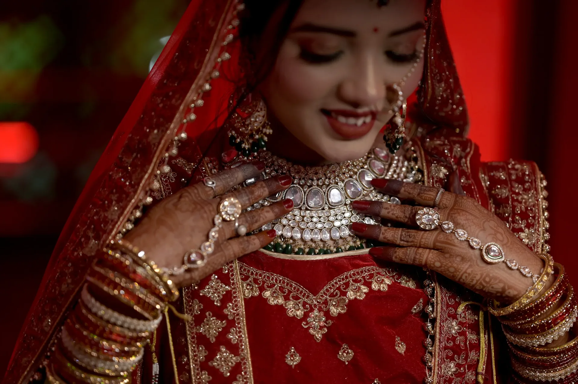 A bride displaying her intricate jewelry and attire
