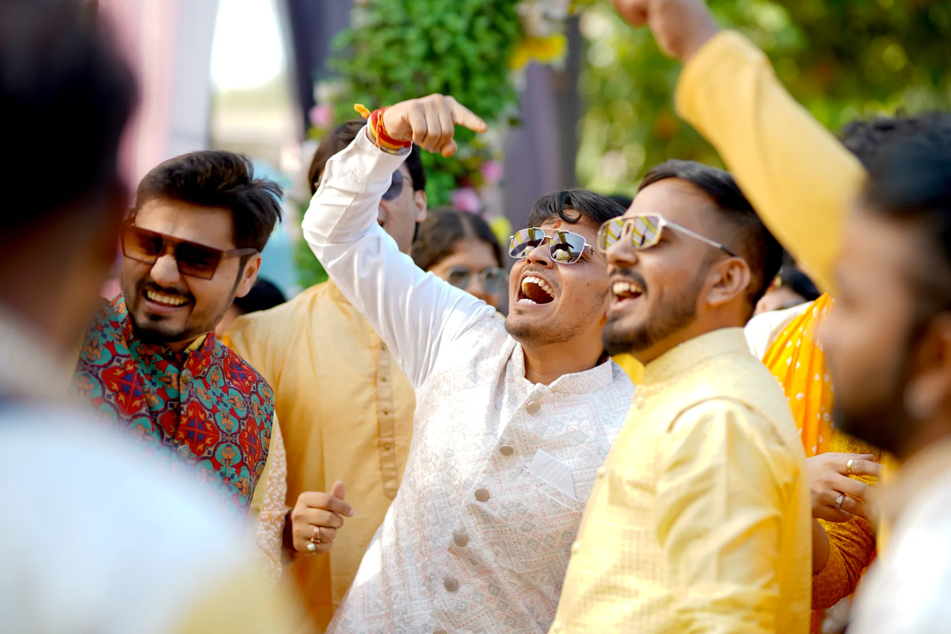 Group of friends celebrating joyfully at a wedding